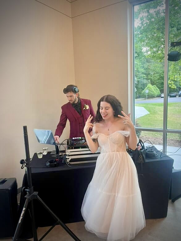 Bride dancing while DJ Jordan performs at a wedding reception